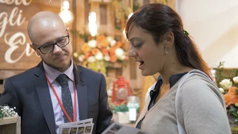 Future bride talks to the shop assistant. Marriage,cerimony,ideas Video stock 98609276