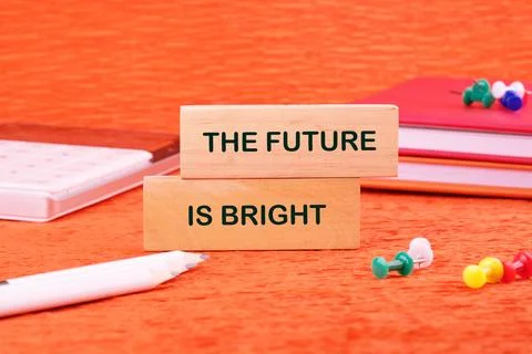 THE FUTURE IS BRIGHT concept words made of wooden blocks on an orange backgro Stock Photos
