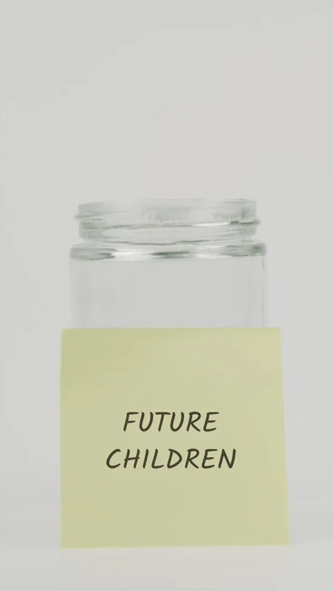 Future children text or word on yellow sticky note attached to glass jar Stock Footage 311737141