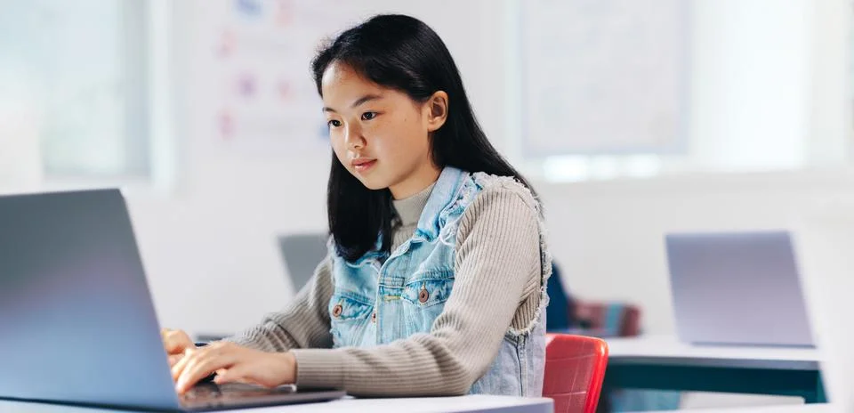 The future coder: Young student learning to programme with a laptop Stock Photos
