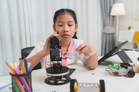 A future engineer learning mechanics and robotics in a STEM workshop. Stock Photos