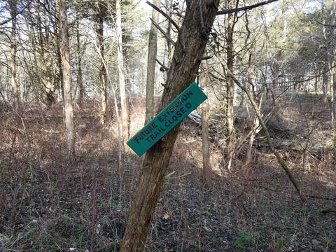 Future extension trail closed sign on tree trunk in woods Stock Photos