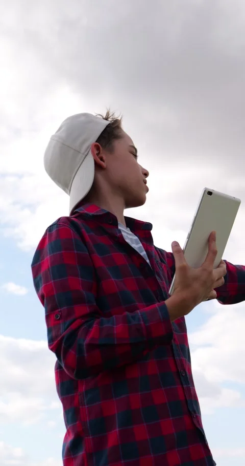 Future farmer uses tablet outdoors under open sky, studying rural environment Stock Footage 343098822