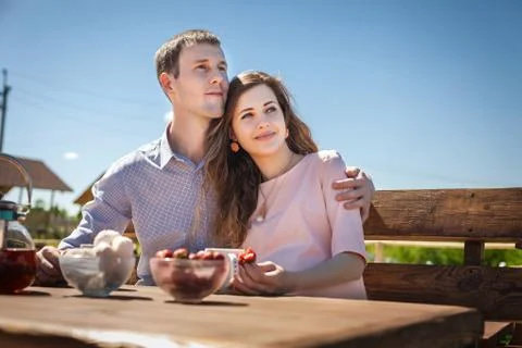 Future mom and dad eating strawberry outdoors Stock Photos