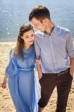 Future mom and dad hugging and walking in nature Stock Photos