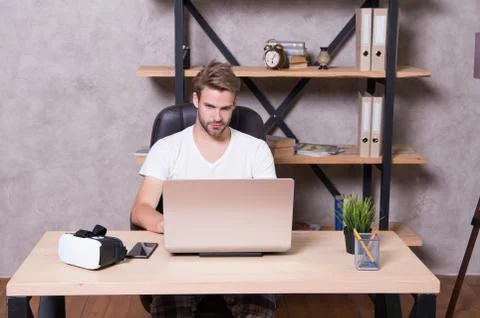 Future is now. Handsome man work on laptop at home. Guy explore VR computer Foto stock