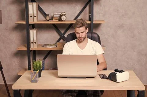 Future is now. Handsome man work on laptop at home. Guy explore VR computer 스톡 사진