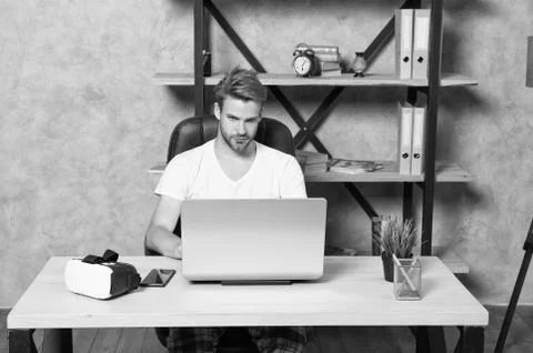 Future is now. Handsome man work on laptop at home. Guy explore VR computer Stock Photos