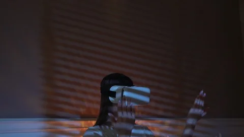 Future Now. Modern VR Gadget at Home. Using Virual Reality Glasses in Bedroom at Stock Footage 125989360