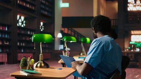 Future nurses studying anatomy class notes in a university library Stock Photos