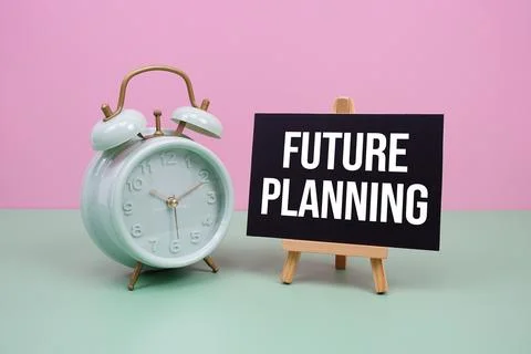 Future Planning text with alarm clock on pink and green background Stock Photos