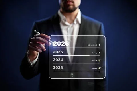 Future planning visualized by a man writing on a digital screen in a dark Stock Photos