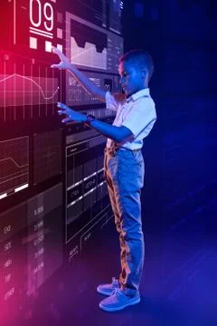 Future programmer controlling the computer system and looking serious 写真素材