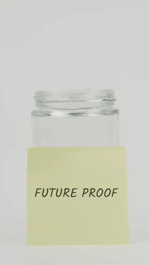 Future proof text or word on yellow sticky note attached to glass jar Stock Footage 311737517