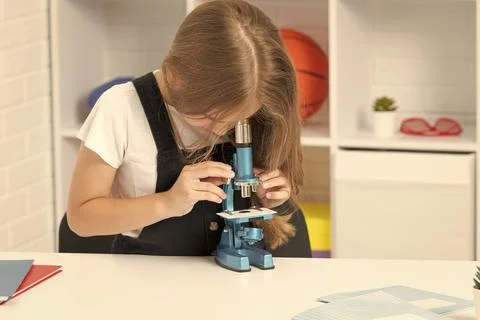 Future scientist kid looking through scope. harness scientific method. science Stock Photos