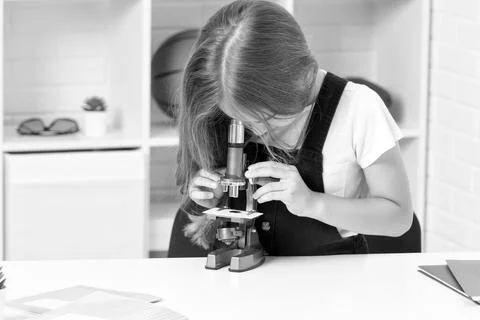 Future scientist kid looking through scope. harness scientific method. science Stock Photos