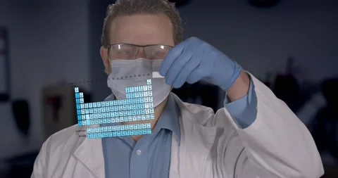 Future Scientist Looking at Periodic Table Hologram Stock Footage 156957518