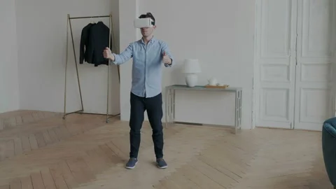 Future is today. General view of young man playing game in vr glasses in Stock Footage 107811147