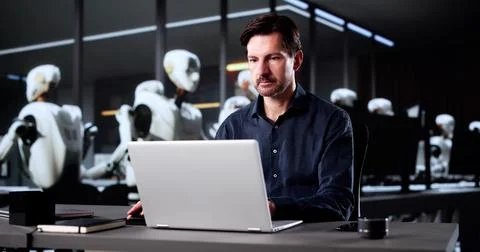 The Future Of Work: Man Using Laptop To Code Stock Photos