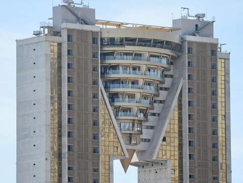 Futuristic building with unique design, innovative skyscraper featuring Stock Photos