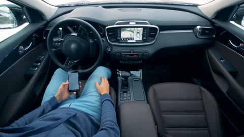 Futuristic car driving by itself. One person sits in a car while it is parking Video stock 100563222