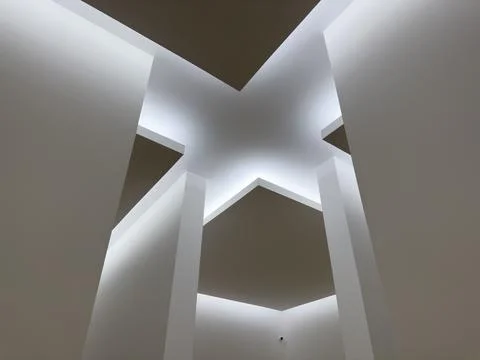 Futuristic ceiling design with intersecting geometric panels and soft diffuse Stock Photos