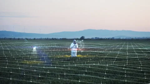 Futuristic concept of engineer using hologram panel scanning farm land. Drone Stock Footage