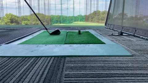 Futuristic golf driving range in japan. The ball comes out of the green carpet Stock Footage 133110504