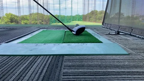 Futuristic golf driving range in japan. The ball comes out of the green carpet Stock Footage 133110814