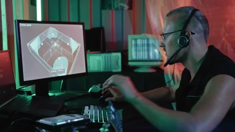 Futuristic Hacker Controlling Security Camera Interface in Neon Hideout Stock Footage 341660365