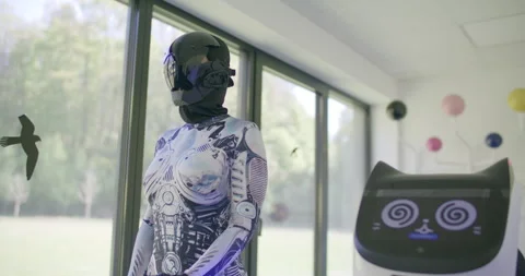 Futuristic humanoid robot in a white suit and helmet standing in a bright room Stockbeeldmateriaal 329486377