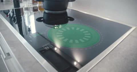 Futuristic induction hotplate with digital control elements in a modern kitchen Video stock 154131511