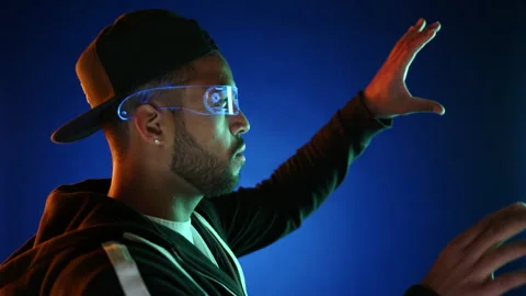 Futuristic Interaction: Man in Augmented Reality Glasses Typing on Virtual Stock Footage 270481873