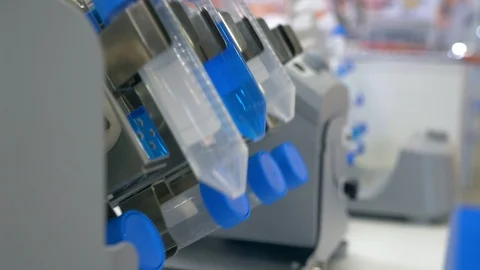 In a futuristic laboratory, analyzes a colored liquid to extract the DNA and Stock Footage 112014972