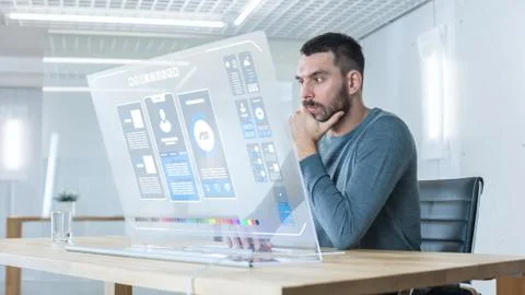 In the Futuristic Laboratory Creative Engineer Works on the Transparent Computer Stock Photos