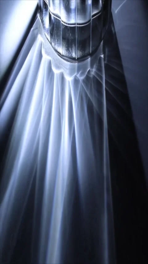 Futuristic light rays emanate from metallic object Stock Footage 339778980