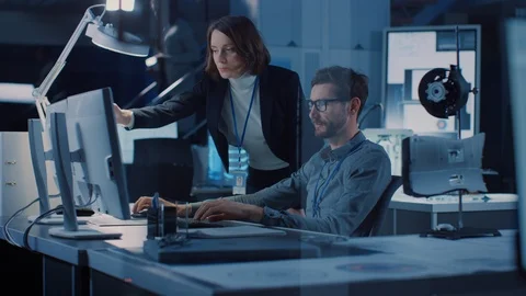 Futuristic Machine Engine Development Engineer Working on Computer at His Desk Stock Footage 104855685