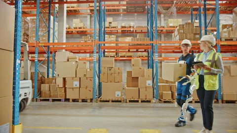 Futuristic Modern Busy Warehouse Worker with Exoskeleton Suit M Stock Footage 141577451