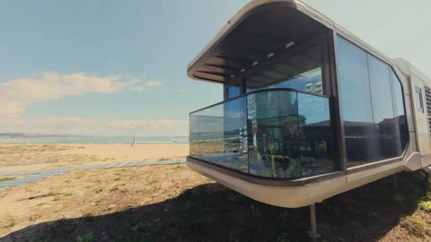 Futuristic Modern Capsule House on Sandy Beach Near the Sea Horizon Stock Footage 346691109