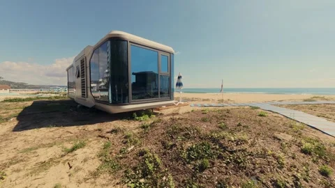 Futuristic Modern Capsule House on Sandy Beach Near the Sea Horizon Stock Footage 346691175