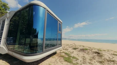 Futuristic Modern Capsule House on Sandy Beach Near the Sea Horizon Stock Footage 346692040