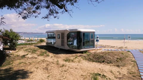 Futuristic Modern Capsule House on Sandy Beach Near the Sea Horizon Stock Footage 346699673