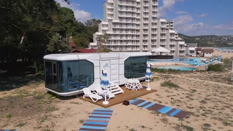 Futuristic Modern Capsule House on Sandy Beach Near the Sea Horizon Stock Footage 346700554