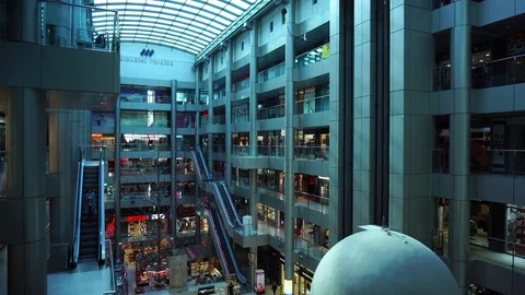 Futuristic modern interior multi store shopping mall with escalators lifts glass Stock Footage 97015243