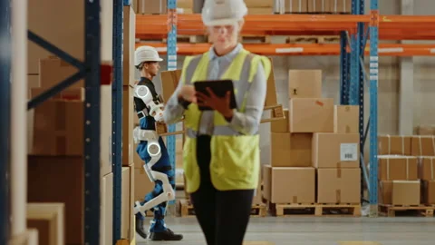 Futuristic Modern Warehouse Worker with Exoskeleton Suit Moves Stock Footage 141576640