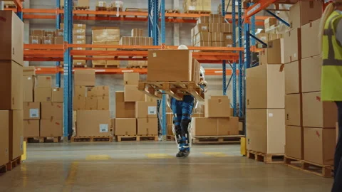 Futuristic Modern Warehouse Worker with Exoskeleton Suit Moves Stock Footage 141576837