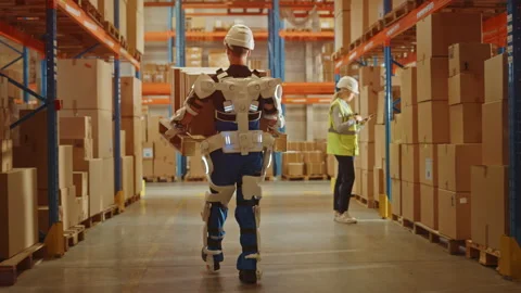 Futuristic Modern Warehouse Worker with Exoskeleton Suit Moves Stock Footage 141576876