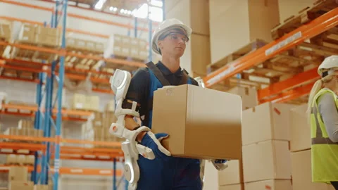 Futuristic Modern Warehouse Worker with Exoskeleton Suit Moves Stock Footage 141577170