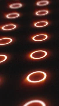 Futuristic pattern of glowing orange rings on dark surface with depth and s.. イラスト素材