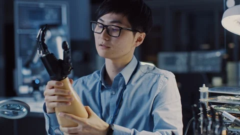 Futuristic Prosthetic Robot Arm Being Tested by Professional Japanese Developer Stock Footage 105343352